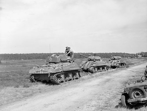 Sherman by Germany Private A.W. Thornton and Captain D. French examining 'Sherman' tank recondit.jpg