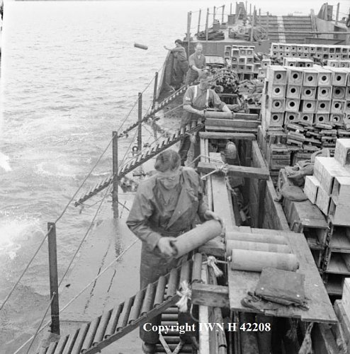 Ammunition dumping ground off Scotland, Royal Army Ordnace Corps place shells on gravity rollers.jpg