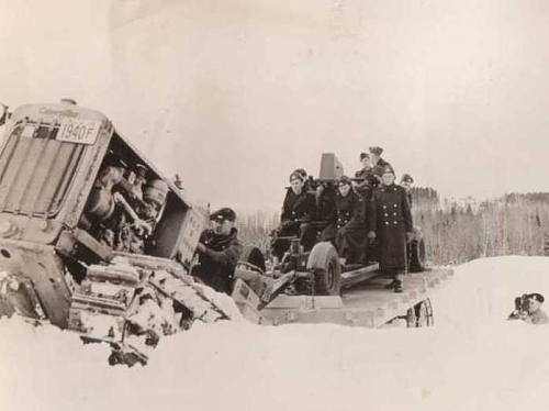 bulldozer towing bofors on tailer.jpg