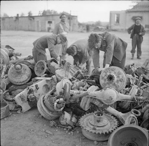 German prisoners in Caen stripping  axels of salvageable parts..jpg